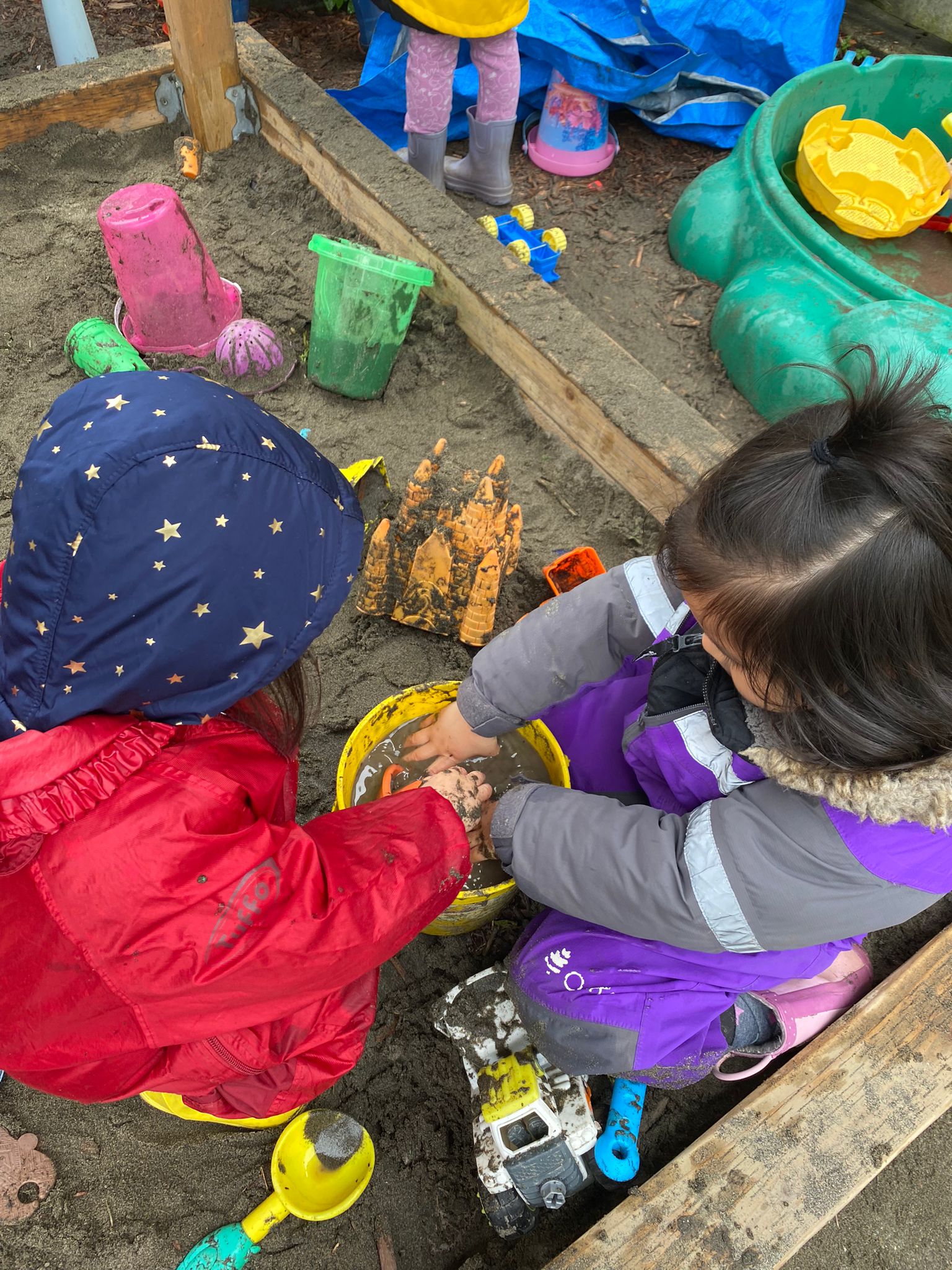 Daycare: Children playing in sandpit.